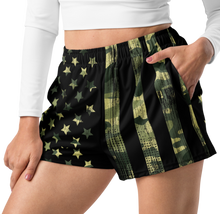  Relaxed fit shorts close up on a woman with her hand in one pocket, athletic running shorts, stars and stripes and camouflage 