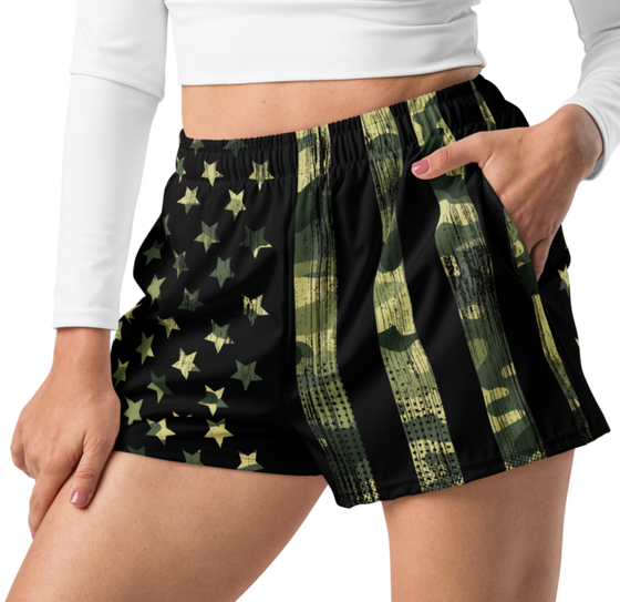 Relaxed fit shorts close up on a woman with her hand in one pocket, athletic running shorts, stars and stripes and camouflage 