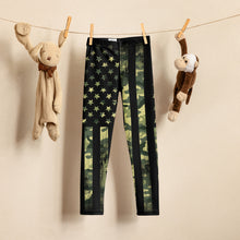  Kids leggings hanging on a clothing wire with toys, from River to Ridge Brand, featuring our camo flag pattern with stars and stripes in camo