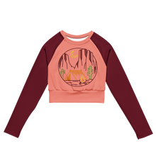  desert camping logo crop top upf shirt for women in peach and maroon and it has a tent and cactus and sedona arizona red rocks and a campfire on it