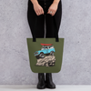 River to Ridge Brand Tote Bag in olive with the Offroad Classic Logo. Featuring a vintage Bronco truck with big tires on a rock with a kayak on top - woman in black holding the purse