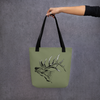 Elk Logo Tote Bag from River to Ridge Clothing Brand featuring a bugling elk with large antlers on an olive green bag  - woman holding the bag out