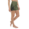 Up close of a woman wearing woodland logo shorts from river to ridge brand in olive OD green that are fitted like yoga shorts and have a high / wide waistband and an elk on the hip