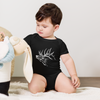 cihild / toddler in an elk one piece onesie in black playing with toys