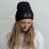 R2R River to Ridge Brand Beanie in black with purple stitching on a woman looking down