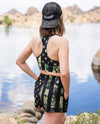 Woman at the lake wearing a Camo Flag Sports Bra and Shorts with pockets, athletic, backwards hat Rockstarlette Outdoors