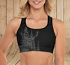 close up of a fit woman wearing an elk sports bra with the river to ridge woodland logo on it in black and grey