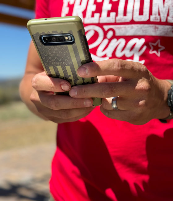 man texting on a samsung phone with a case on it with an olive tactical logo, from River to Ridge - USA patriotic phone case