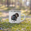 River to Ridge Brand enamel camping coffee mug sitting in the moss in the forest and the cup has a drawing of a turkey on it with a long beard strutting, hunting cup