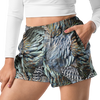 close up of woman wearing relaxed fit athletic shorts with pockets in a turkey feather pattern from river to ridge and a white crop top shirt