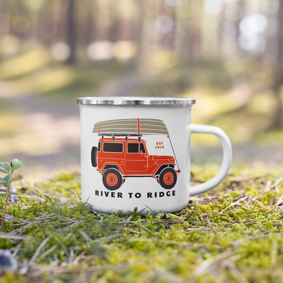 River to Ridge Enamel Camping Cup with a jeep on it in orange and a boat on top, offroad weekend cup sitting in the moss in the forest