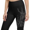 Close up of woodland capri leggings which have an elk in the forest on them in black, womens