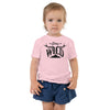 toddler in pink T shirt with stay wild logo and antlers and mountain 