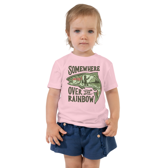 Little girl wearing a somewhere over the rainbow trout logo fishing shirt in pink from river to ridge outdoors and a little blue toddler skirt