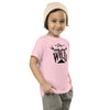 little girl in a beanie with a pink t shirt that says stay wild with antlers and a mountain