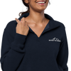 Womens Half zip pullover from River to Ridge clothing brand with the logo on the left chest and sleeve - close up of woman wearing it in navy blue
