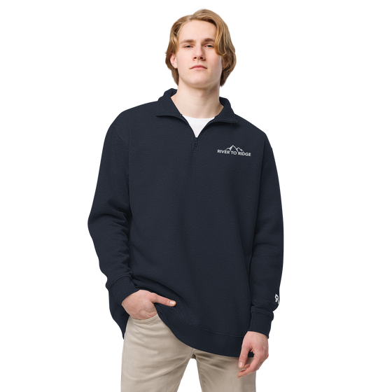 Man wearing Unisex River to Ridge half zip pullover in navy blue  with embroidery logo on chest and sleeve for R2R in white