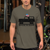 man at the gym wearing a vintage truck logo t shirt in army olive green with an american flag out the window. bronco is in black from the brand River to Ridge