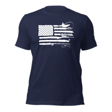  River to Ridge T shirt in navy blue with the sportsmans flag on it which is the american flag with elk antlers, a man fishing for bass, goose hunting and fly fishing inlucded in the stripes