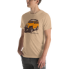 Mens T shirt in tan with a drawing of a landcruiser offroading truck in yellow with big tires from the brand River to Ridge - on a young man in jeans