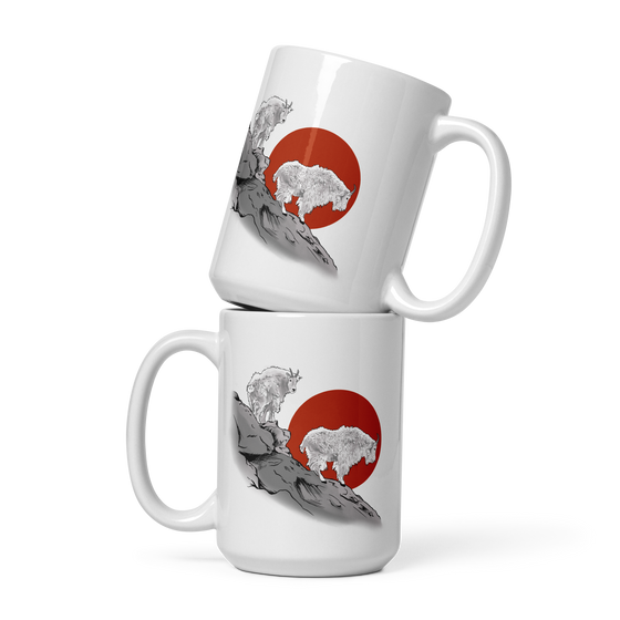 two coffee mugs stacked up with Mountain Goats on them standing on a mountain side