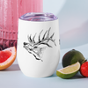 cocktails in an elk wine tumbler with limes and an elk with big antlers on the side of the cup for wine or hot drinks