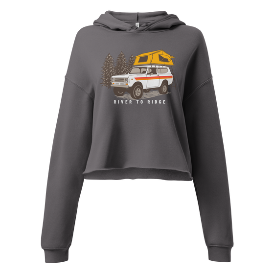 Vintage Truck Camping Logo with a Scout and a tent on top on a cropped hoodie from River to Ridge Brand for women