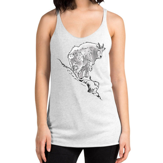 Woman wearing a white ash tank top, racerback with a mountain goat on a  ledge on it