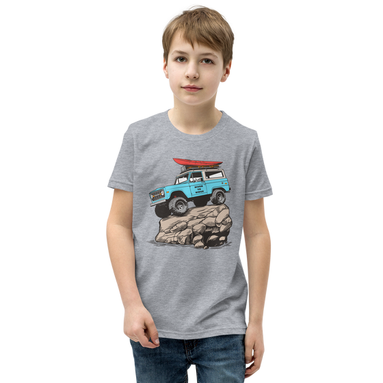 Offroad classic logo T shirt for kids from River to Ridge Brand. Features a Bronco up on a rock with big tires on it and a red kayak on top, vintage truck T. Photo of little boy wearing the T shirt