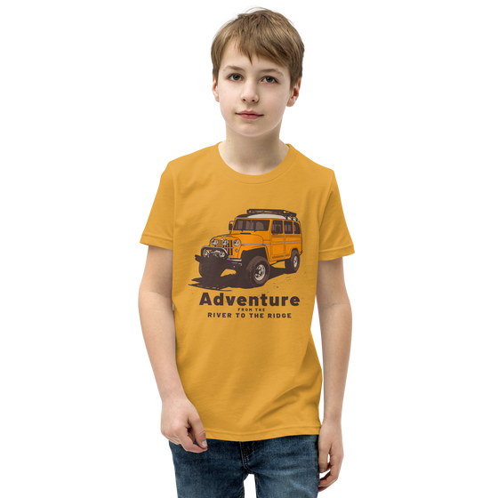 Kids T shirt on a boy in mustard yellow with an offroad truck and adventure logo from the brand River to ridge