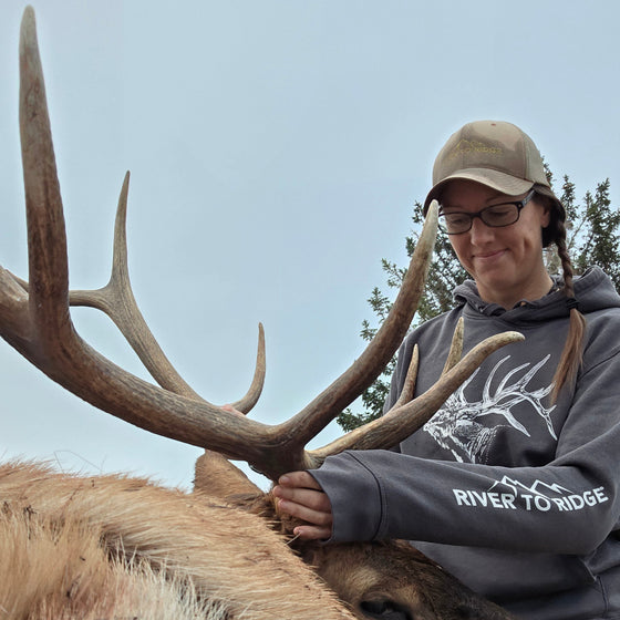 Person posing with a large elk
