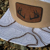 Cap with deer antler design on a textured surface