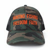 Camouflage cap with orange text 'Hunting Fishing Freedom Faith' on a white background