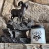 Jar of candle, Follow God's Word on a stone surface with a decorative metal horse.