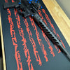 Black rifle on a black surface with red weapon silhouettes