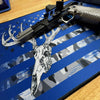Close-up of a rifle with a blue and white graphic design on a wooden surface