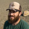 Trucker hat with duck hunting design on a gravel surface
