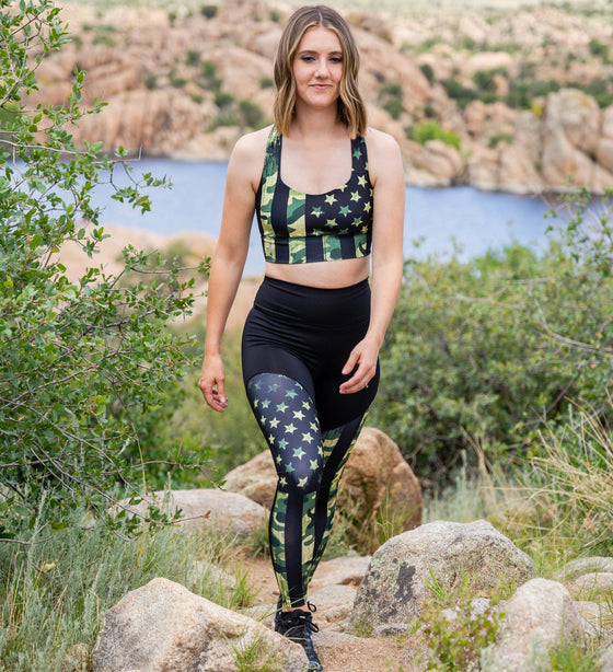 woman hiking in a camo flag sports bra and matching compression leggings at the watson lake park in prescott arizona