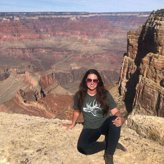 woman at the Grand Canyon wearing a green elk antler t shirt from River to Ridge Clothing