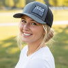 Person wearing a cap with 'Jesus Saves' text in an outdoor setting