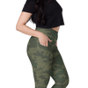 Woman wearing green camouflage leggings on a white background