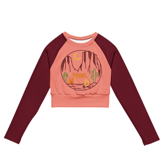 desert camping logo crop top upf shirt for women in peach and maroon and it has a tent and cactus and sedona arizona red rocks and a campfire on it