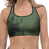 Woman wearing a green sports bra and dark gray leggings on a white background
