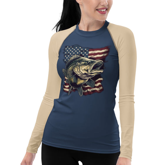 Product mockup of a Bass Fishing UPF 50 women's rash guard shirt in blue and beige with a bass over the USA flag