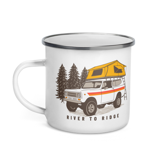 Enamel coffee mug from River to Ridge Clothing Brand with a vintage scout truck on with a tent on top camping in the forest