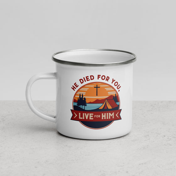 Product mockup of a Christian enamel camping mug from River to Ridge clothing brand featuring the saying "he died for you, live for him" and a camping scene in red and orange and blue