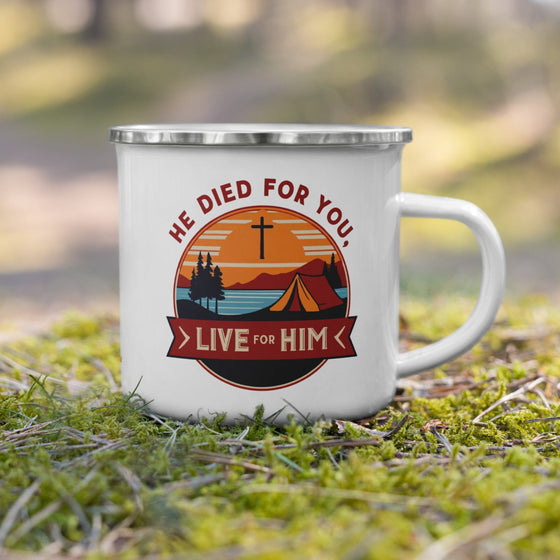 Product mockup of a Christian enamel camping mug from River to Ridge clothing brand featuring the saying "he died for you, live for him" and a camping scene in red and orange and blue