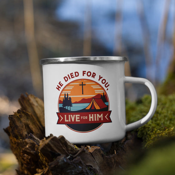 Product mockup of a Christian enamel camping mug from River to Ridge clothing brand featuring the saying "he died for you, live for him" and a camping scene in red and orange and blue