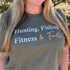 Person wearing a t-shirt with text 'Hunting, Fishing, Fitness & Faith' outdoors.