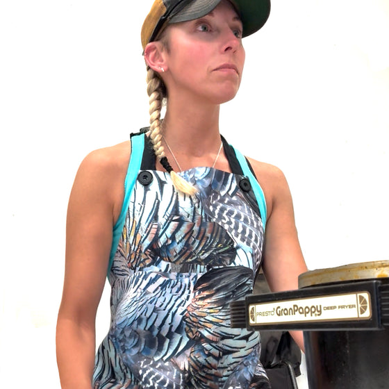 Woman holding a deep sea fishing reel with a white background